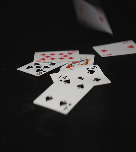 Playing Cards. Playing cards falling on black table